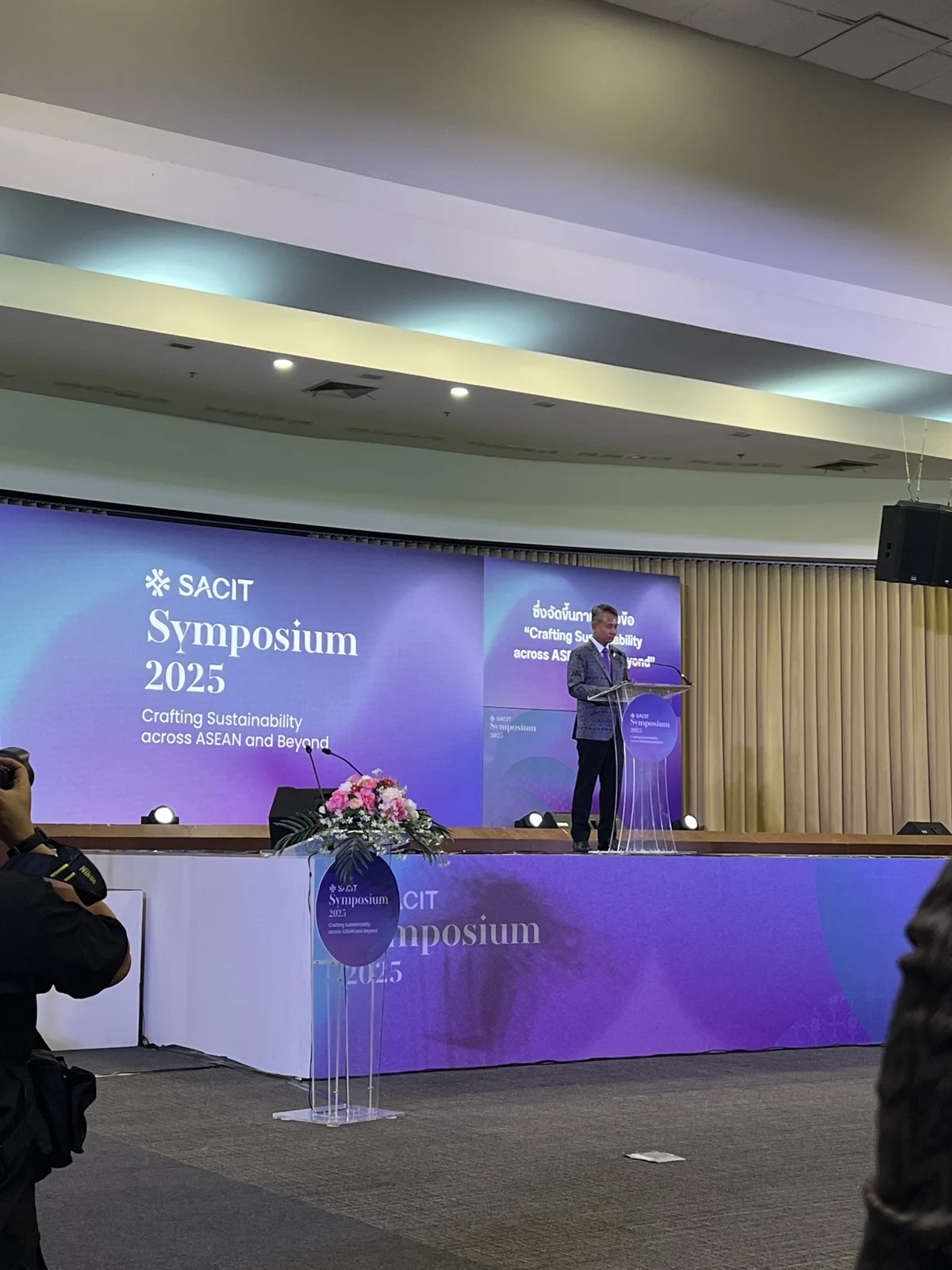 A speaker at a design symposium
